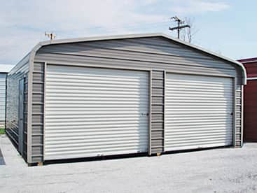 22x26x7 metal garage from Salem Structures featuring dual roll-up doors, horizontal steel siding, and a durable all-metal frame.